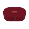 A dark red oval-shaped jewelry box with a small gold metal plaque on the front that reads 'KISSKY' and a matching dark red leather strap closure, shown on a clean white background.