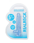 Crystal clear dildo in packaging with 'Real Rock' branding on a white background