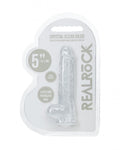 Clear dildo in packaging with 'Real Rock' branding on a white background