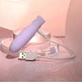 Purple electronic device with a USB cable on a pink surface