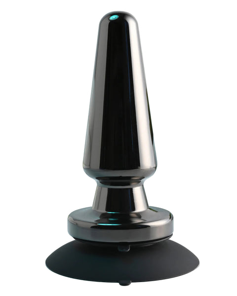 Black and silver device on a light blue surface with plants in the background