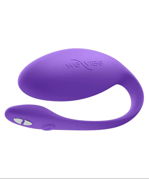 A purple silicone personal massager by We Vibe, featuring a curved design with a small white button on the handle, shown against a plain white background.