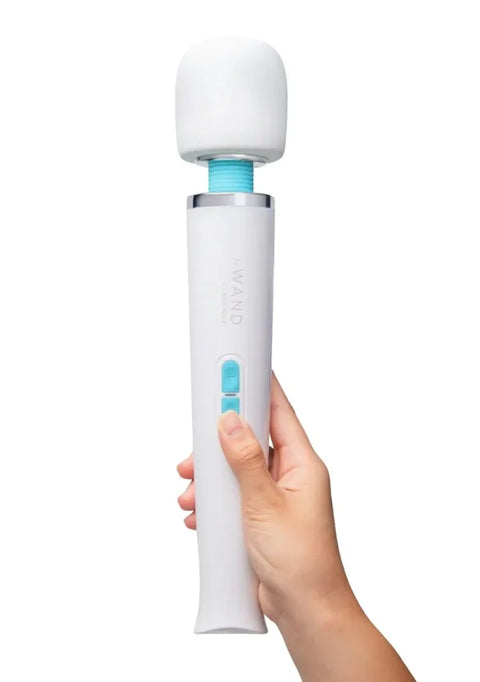 Hand holding a white and blue electronic device on a white background