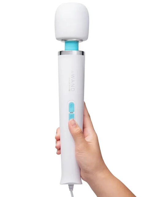 Hand holding a white and blue handheld device on a white background